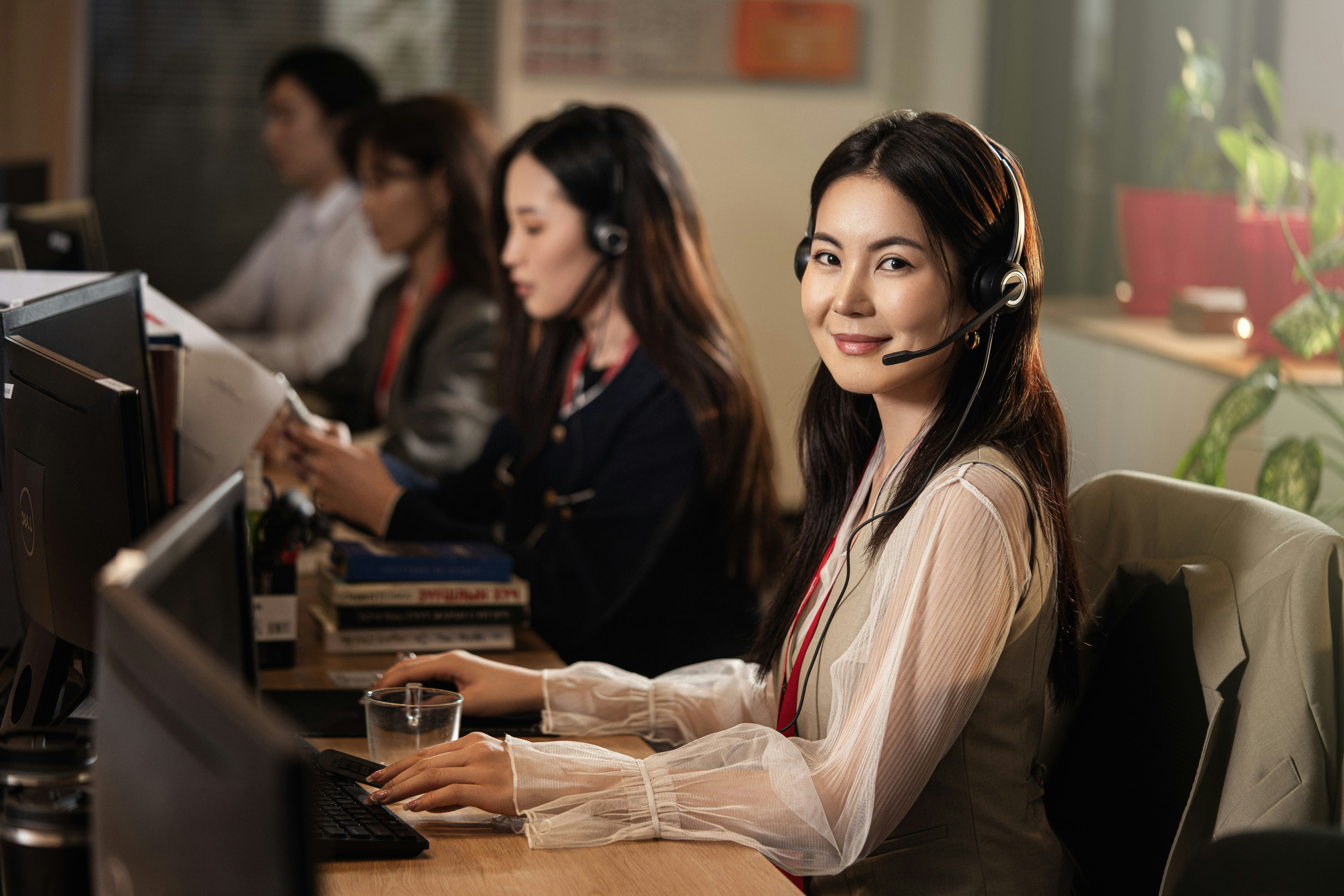 Support specialist wearing a headset at a computer